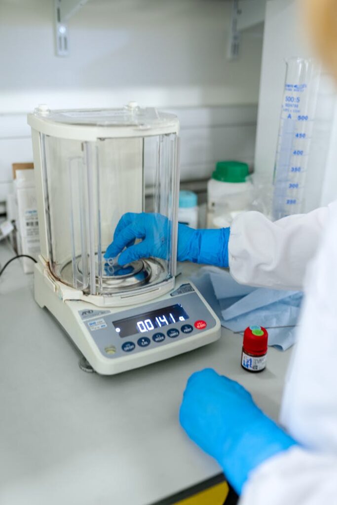 Scientist uses digital scale for precise measurements in a lab setting.
